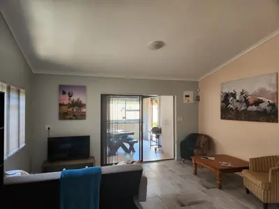 a living room with a couch and a table at Thys' Place in Cape Town
