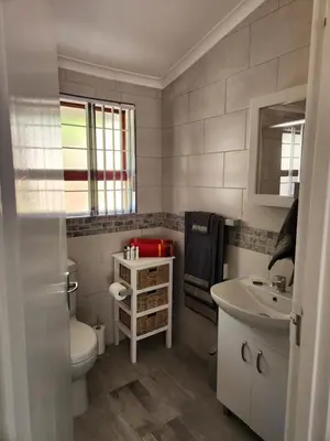a bathroom with a toilet and a sink at Thys' Place in Cape Town