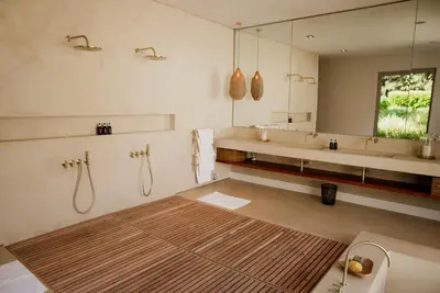 a bathroom with two sinks and a large mirror at MAISON FRANSCHHOEK in Franschhoek