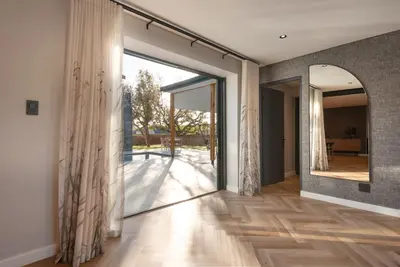 a hallway with a large glass door leading to a patio at Villa Paradys - Serviced in Stellenbosch