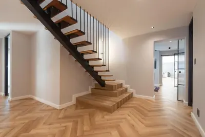 a staircase in a home with wood floors at Villa Paradys - Serviced in Stellenbosch