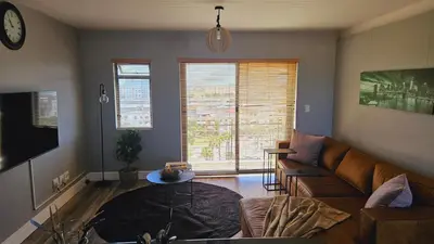 a living room with a couch and a table at SS Luxury Apartments in Cape Town