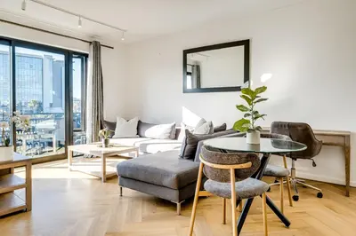 a living room with a table and a couch at Belina - Nine Palms Premier in Cape Town