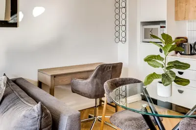 a living room with a couch and chairs and a table at Belina - Nine Palms Premier in Cape Town