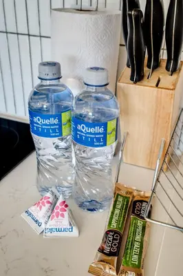 two bottles of water sitting on top of a counter at Belina - Nine Palms Premier in Cape Town