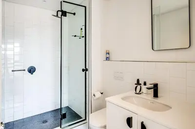 a bathroom with a sink and a glass shower at Belina - Nine Palms Premier in Cape Town