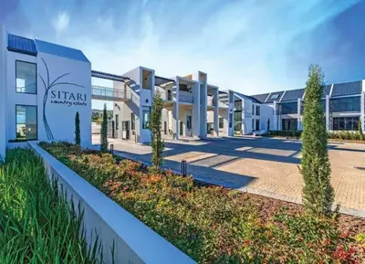 a building with a sign in front of it at Sitari County Estate - The Most Iconic Estate in Cape Town