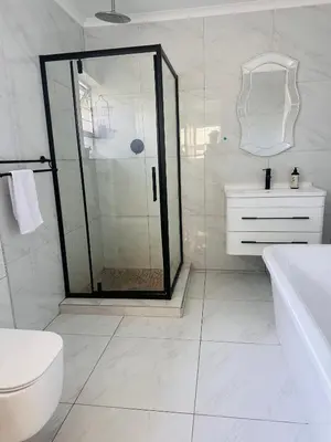 a bathroom with a shower and a toilet and a sink at Entertainers delight near the beach & wine routes in Cape Town