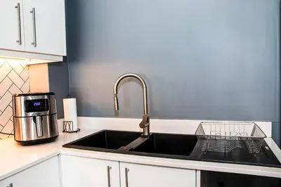 a kitchen sink with a faucet on top of it at B&B Sitari County Estate - The Most Iconic Estate in Cape Town
