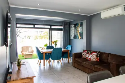 a living room with a couch and a table at B&B Sitari County Estate - The Most Iconic Estate in Cape Town