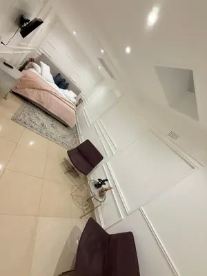 a room with a bed and two chairs in it at DOMIN LUXURY SUITES in Cape Town