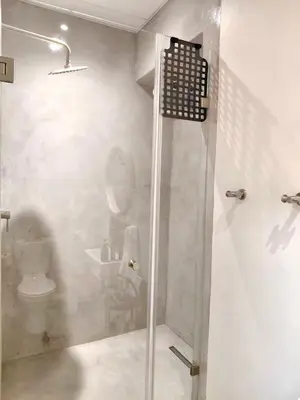 a bathroom with a glass shower with a toilet at The Stetson - Paarl - Self Catering Apartment in Paarl