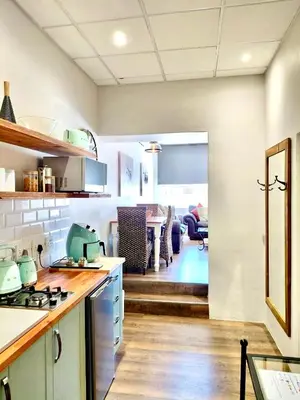 a kitchen with a stove and a dining room at The Stetson - Paarl - Self Catering Apartment in Paarl