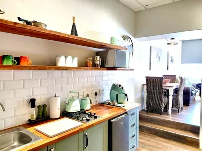 a kitchen with a sink and a stove top oven at The Stetson - Paarl - Self Catering Apartment in Paarl