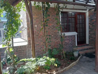 a brick house with a door and a garden at Marinda's B&B in Cape Town