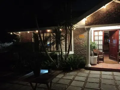 a house lit up at night with a patio at Marinda's B&B in Cape Town