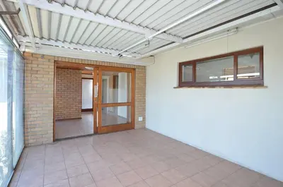 an empty room with a door and a brick wall at 37 Toner Street North in Cape Town