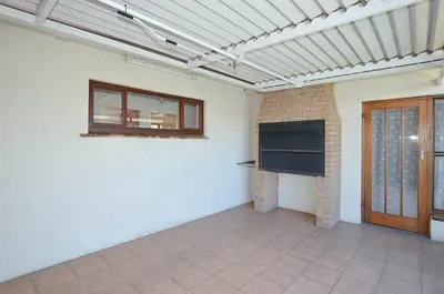 an empty room with a brick fireplace and a window at 37 Toner Street North in Cape Town