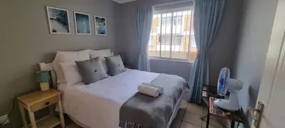 a bedroom with a bed and a window at Ocean Escape in Strand