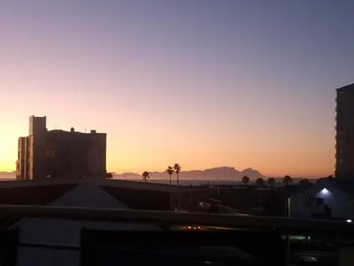 a sunset from the roof of a building at Ocean Escape in Strand