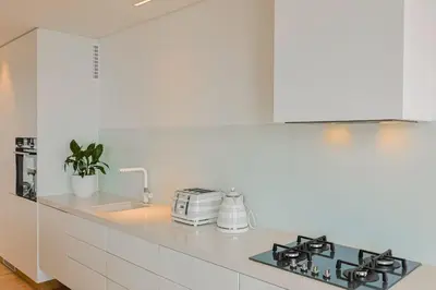 a white kitchen with a stove and a sink at 91 Atlantic Drive in Hermanus