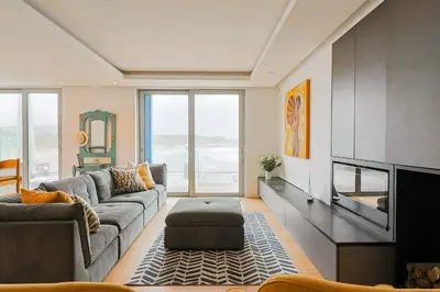 a living room with a couch and a tv at 91 Atlantic Drive in Hermanus