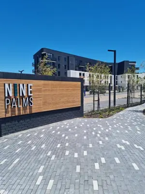a sign that reads nine palms in front of a building at 9 Palms by Smart City Stays in Cape Town