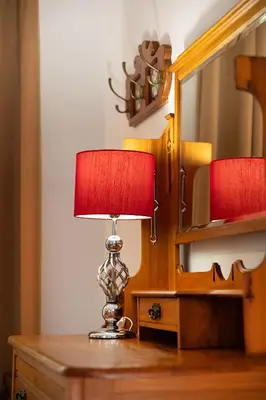 a lamp sitting on a dresser next to a mirror at 55 MainStay in Hermanus