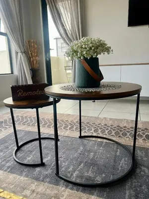 a table with a vase of flowers on top of it at The CoziPlace One in Cape Town