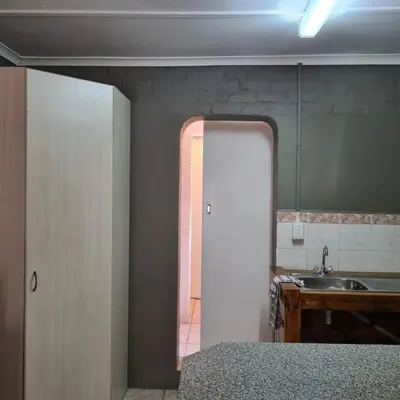 a bathroom with a sink and a mirror at Mads Place in Cape Town