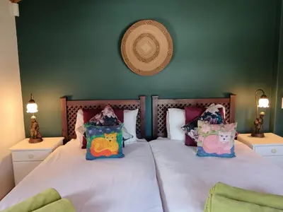 a bedroom with a bed with pillows on it at d'Vine Maison in Franschhoek
