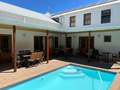 a swimming pool in front of a house at d'Vine Maison in Franschhoek