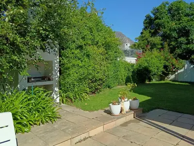 a garden with potted plants on a patio at d'Vine Maison in Franschhoek