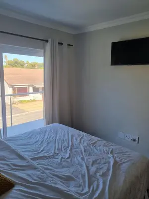 a bedroom with a bed and a large window at 5 AntiP in Cape Town