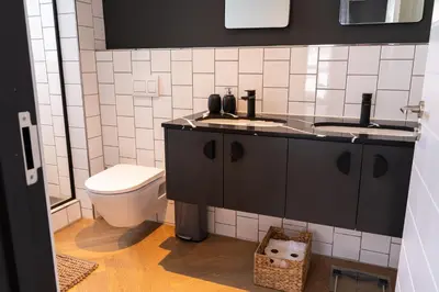 a bathroom with a sink and a toilet at KML Nine Palms luxury 101 in Cape Town