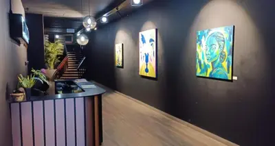 a room with paintings on a wall with a counter at NEW BOSTON in Bellville