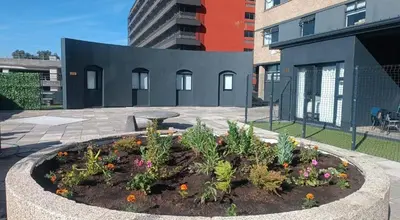 a garden in the middle of a courtyard with buildings at NEW BOSTON in Bellville