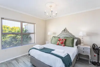 a bedroom with a large bed and a window at Dorphene 304 by CTHA in Cape Town