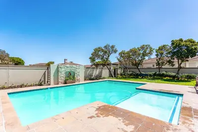 a swimming pool in the backyard of a house at Dorphene 304 by CTHA in Cape Town