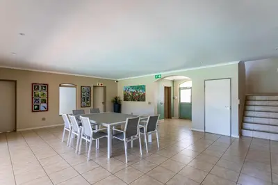 a dining room with a table and chairs at Dorphene 304 by CTHA in Cape Town