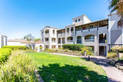 a large white building with a lawn in front of it at Dorphene 304 by CTHA in Cape Town