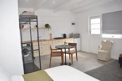 a small kitchen with a table and a kitchen gmaxwell gmaxwell gmaxwell gmaxwell gmaxwell at House on Pringle in Cape Town