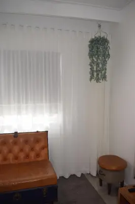 a living room with a couch and a window at House on Pringle in Cape Town