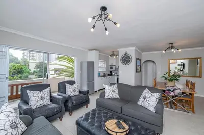 a living room with a couch and two chairs at Island view on Clam in Cape Town