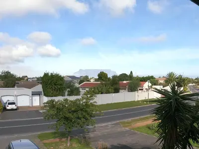 a street in a residential neighborhood with a white fence at Blue Mountain View in Cape Town