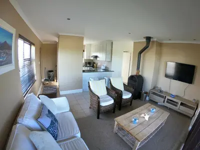 a living room with a couch and a table at Blue Mountain View in Cape Town