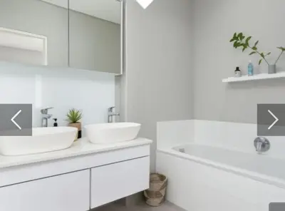 a white bathroom with two sinks and a tub at Franschhoek - La Petit Village - Views in Franschhoek