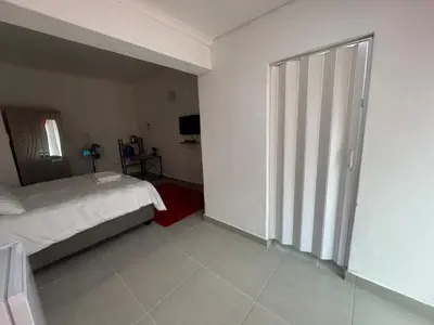 a bedroom with a bed and a sliding glass door at No 1 Guest house in Cape Town