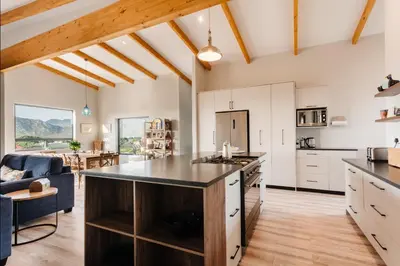 an open kitchen and living room with a large island at Prinia on Peak in Pringle Bay in Pringle Bay