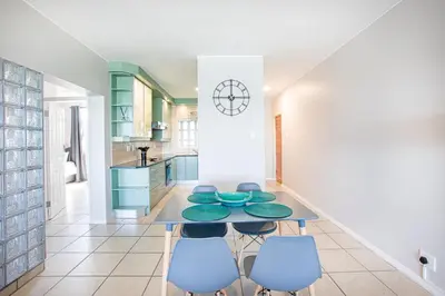 a kitchen with a table and four chairs at Isla's Place (Strandsig 304) in Cape Town